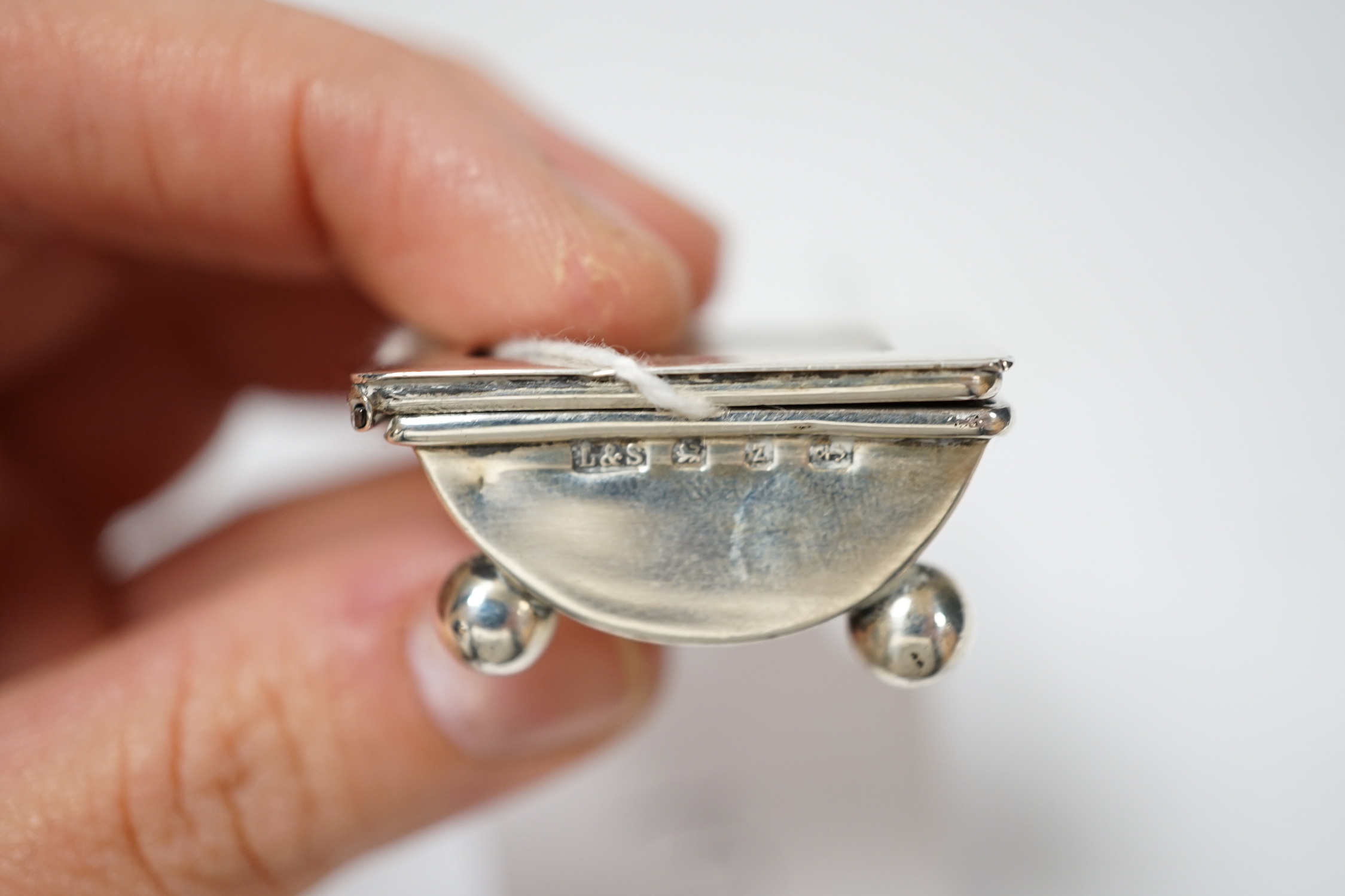 Four assorted late 19th/early 20th century silver stamp boxes, including triple compartment, one with enamelled 'stamps', largest 9cm and one plated stamp box.